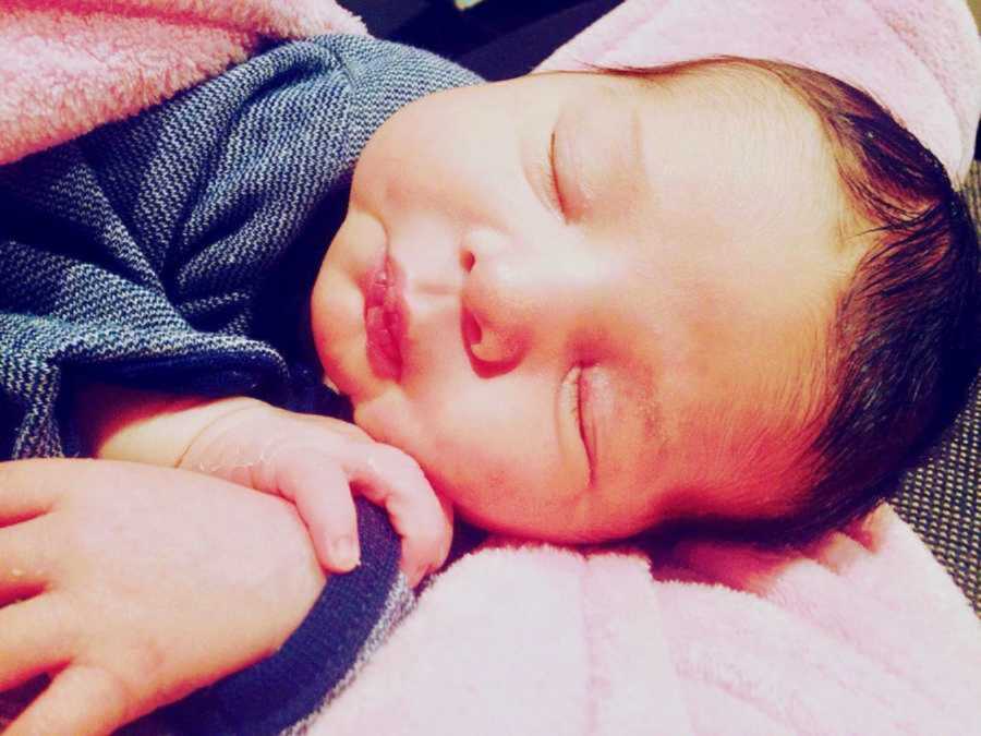 baby peacefully sleeping wrapped in blankets