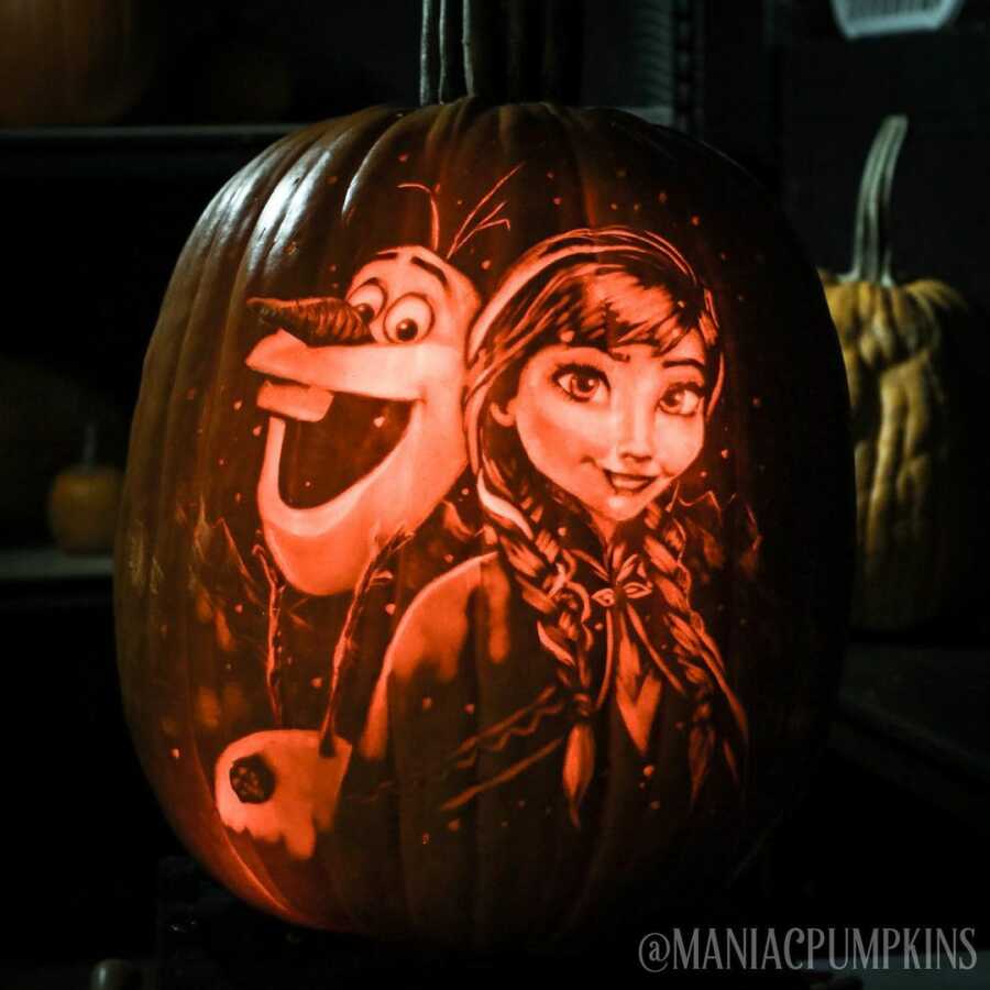 Detailed pumpkin carving of Olaf and Anna, created by Maniac Pumpkin Carvers.
